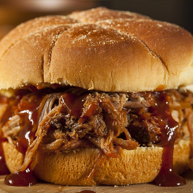 Pulled pork sandwich dripping with BBQ sauce